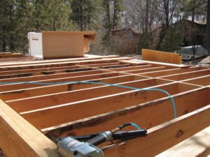 Wooden deck construction with tools and materials.