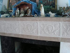 Nativity scene on decorative marble fireplace mantle.