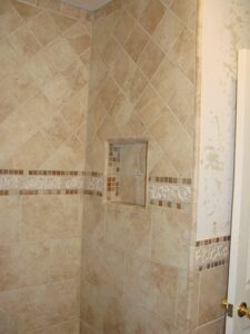 Tiled shower enclosure with beige design.