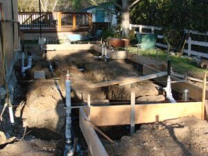 Backyard under construction with wooden framework for renovation.