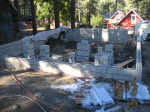 Construction site with concrete blocks and building foundation.