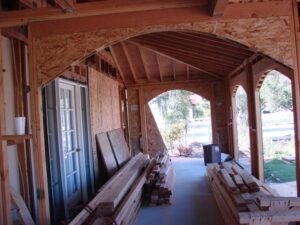 Home construction with exposed wooden framing and materials.