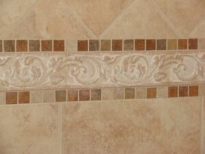 Decorative ceramic tile wall with ornate border design.