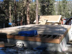 Construction site foundation with trees in background