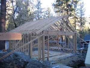Wooden house frame construction in progress.