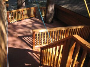 Wooden deck with railing in sunlight.