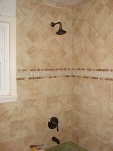 Tiled shower corner with bronze fixtures
