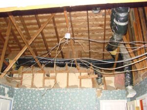 Exposed insulation and wiring in house renovation.