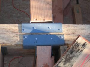Construction beams with metal connector plate.