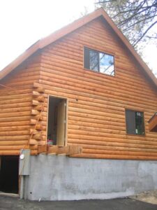 Wooden cabin exterior with large gable roof.