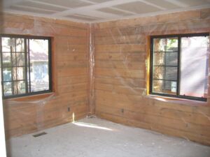 Interior room under construction with insulation visible.