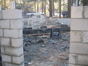 Construction site, cinder blocks, foundation work in progress.
