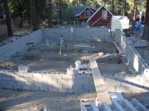 Construction site with concrete blocks and leveling equipment.