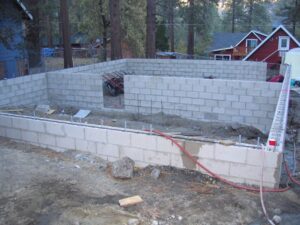 Cinder block wall construction at residential site.