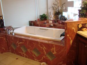 Luxurious marble bathroom with white bathtub.