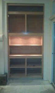 Empty wooden bookshelf in room.