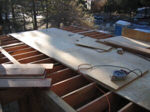 Wooden roof construction with circular saw and materials.