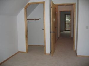 Empty room with carpet and open doors