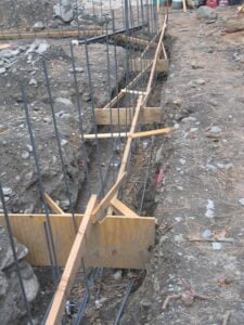 Construction site with rebar foundation framework.