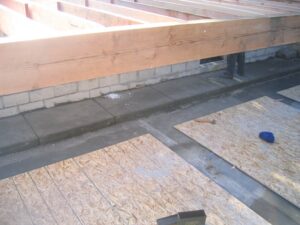 Construction site with unfinished wooden flooring and walls.