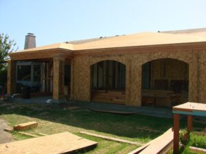 House under construction with exposed plywood exteriors.