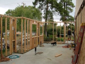Construction site framing in progress with a worker.